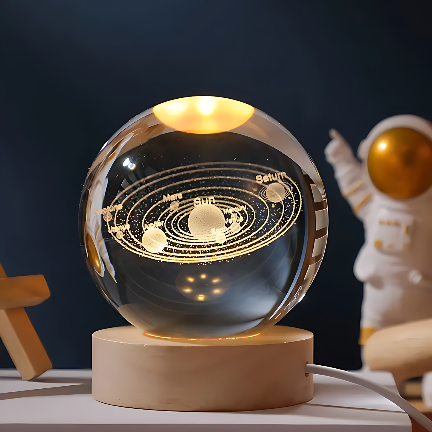 "Crystal ball with moon phase design glowing on dark stand"